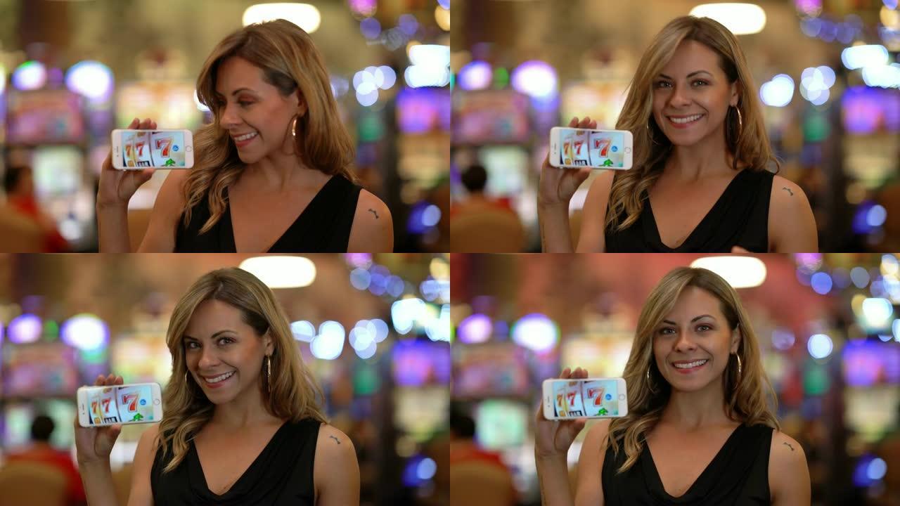 美丽的拉丁美洲女人在赌场拿着智能手机在屏幕上显示幸运的777