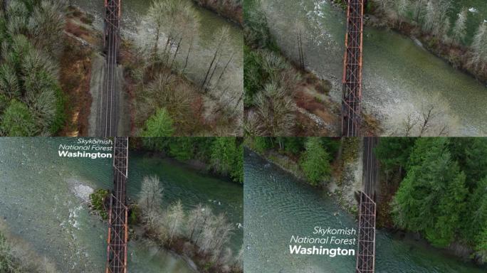 自上而下的无人机拍摄了Skykomish河上生锈的铁路桥，并带有浮动文字