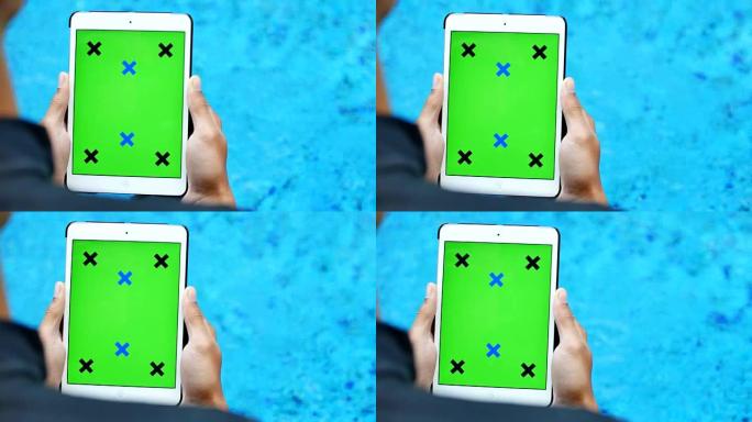 游泳池附近的绿屏平板电脑