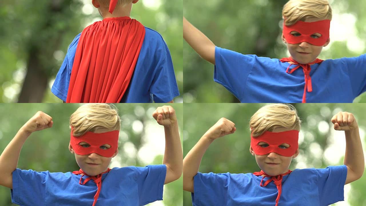 坚强的超级男孩戴着面具和服装表现出力量，自信
