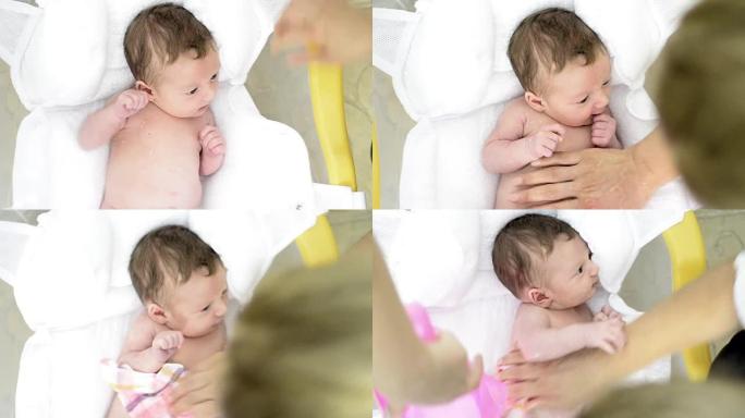 两天大的新生婴儿洗澡的镜头。