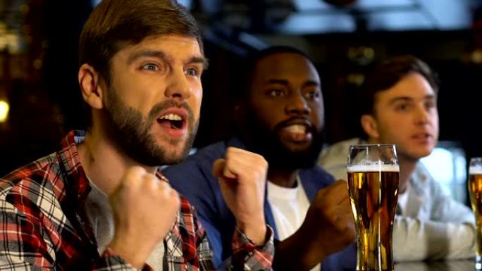 男性朋友在酒吧支持运动队，对球越位感到失望