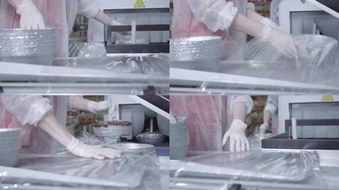 无法识别的高加索女工厂工人使用吸尘机包装成品。在工厂生产食品容器的职业女性。工业、商业。