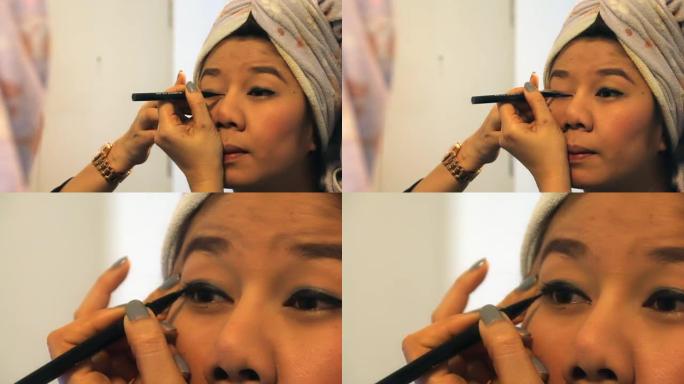 女人使用眼线笔化妆美容