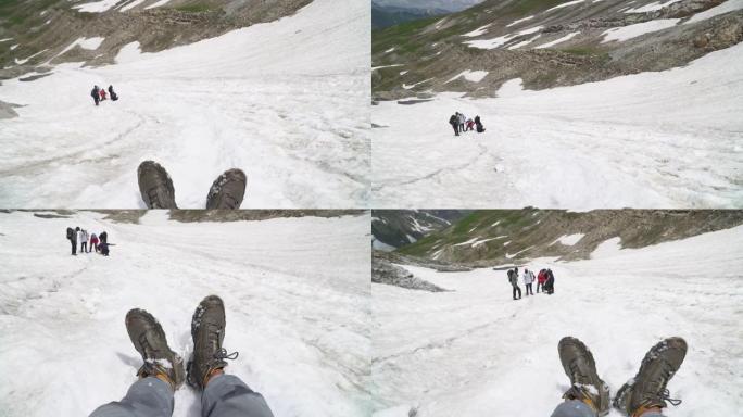 徒步旅行者等待着那个人从白雪皑皑的风景上滑下来