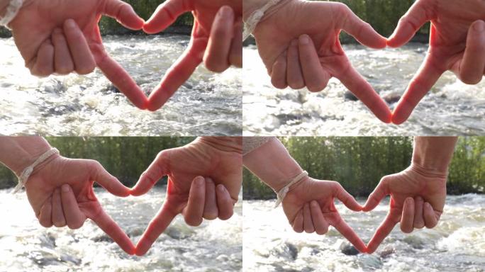 女人的手在山河之上创造心形