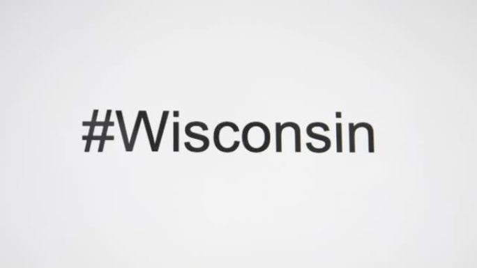 一个人在他们的计算机屏幕上键入 “# Wisconsin”，然后跟随状态缩写