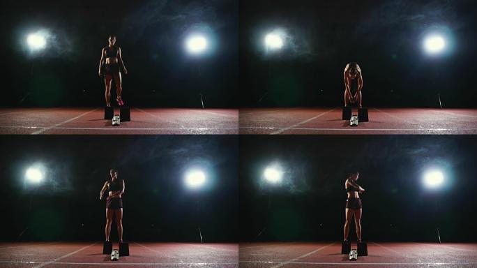 职业女运动员在黑暗的背景下，在体育场的跑道上，在黑暗的背景下，穿着运动鞋跑慢跑鞋的冲刺。平均计划