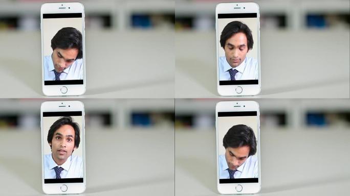 年轻的男性律师在智能手机上收听机外客户。