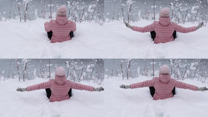 女人看着雪花落在白雪皑皑的森林里