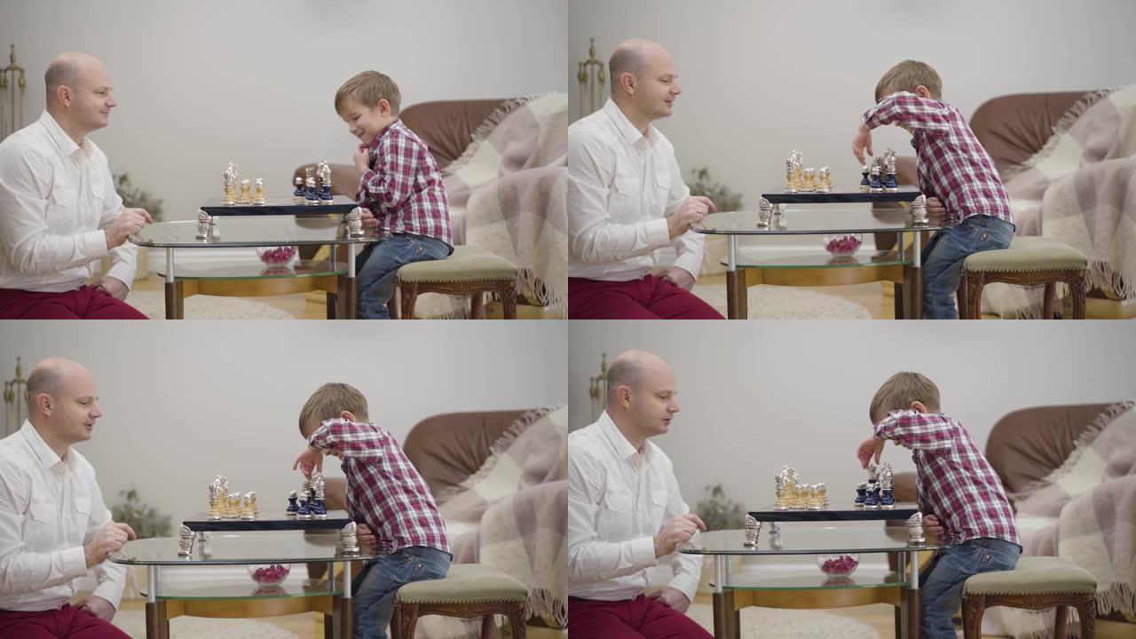 成年高加索人教小儿子下棋的侧视图。可爱的小男孩在家和父亲一起学习。团结、智慧、教育。