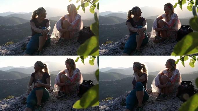 母亲和女儿在日出时在森林和山丘上放松