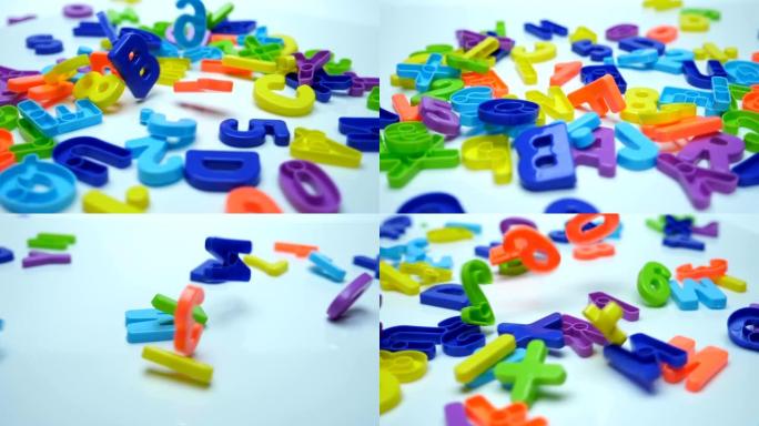 儿童游戏中明亮的多色字母和数字掉落