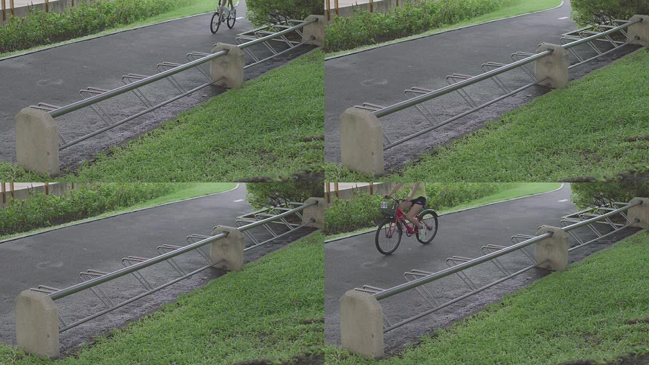 公园里的自行车停放和骑自行车的人。