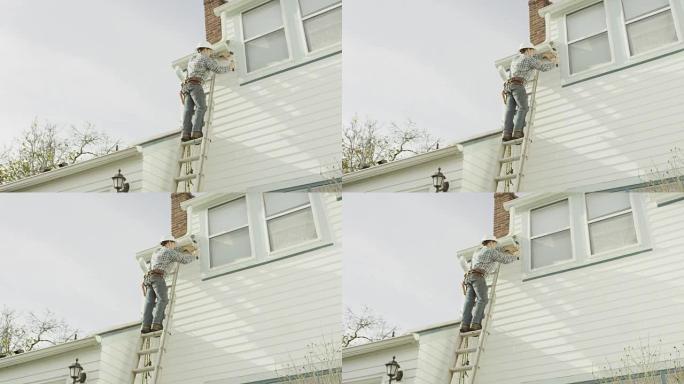 成年男性建筑工人在住宅上修理