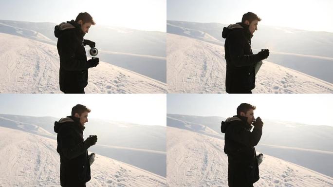 Man pours tea from a thermos winter