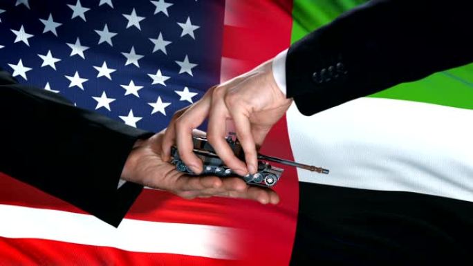美国和阿联酋官员在国旗背景，伙伴关系上交换金钱