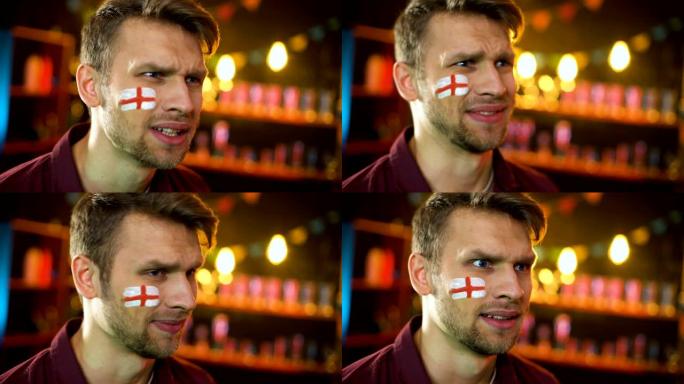 球迷脸上画着英国国旗，对球队输了比赛很不高兴