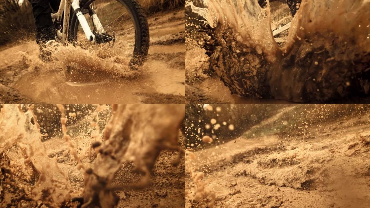 超级慢动作: MTB骑自行车的人在相机上溅泥