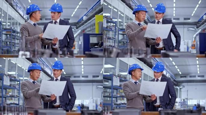 DS亚洲男工程师持有计划并与工厂所有者交谈