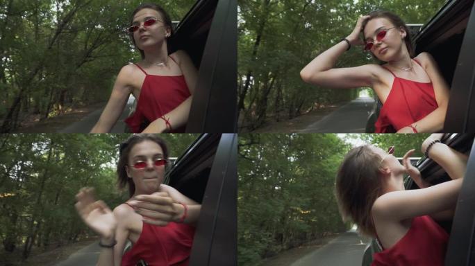 可爱的女孩把头伸出车窗风飘扬女人头发女士在车里跳舞