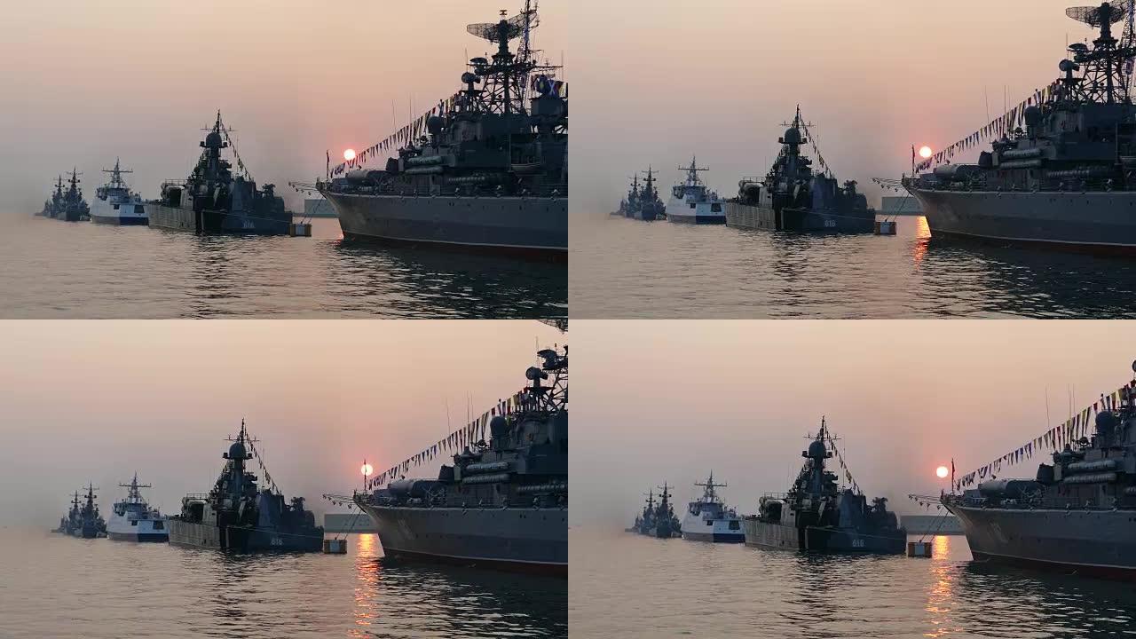 日落时海湾中的军用船只