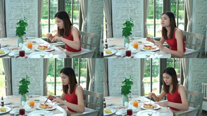 4k镜头妇女坐在酒店吃早餐