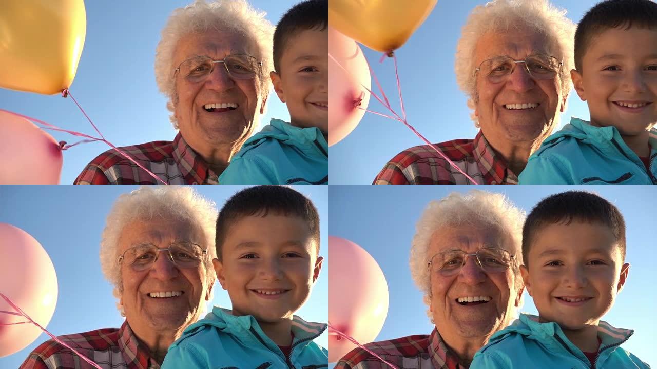 祖父带着快乐的孙子看着相机