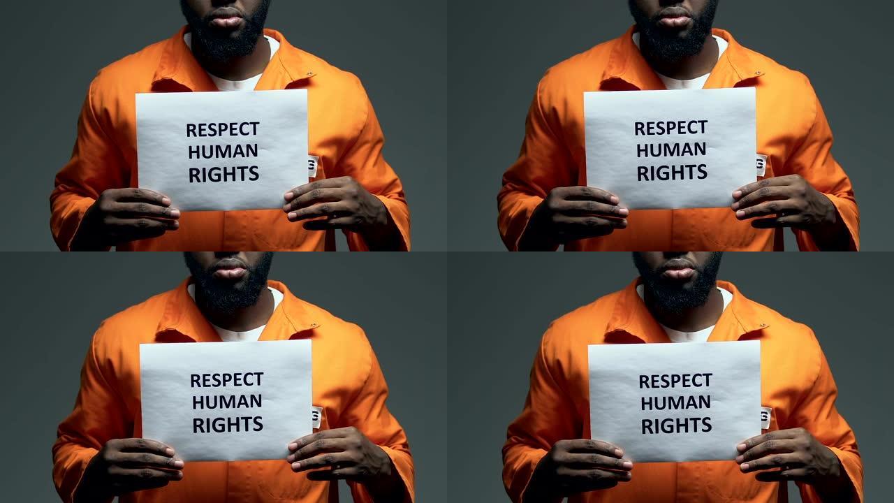在美国黑人囚犯手中的纸板上写着“尊重人权”
