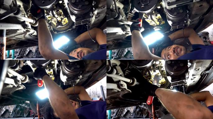 4K: 在车辆下工作的汽车修理工。