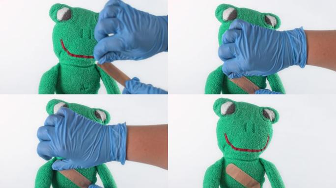 SLO MO LD医生在毛绒青蛙玩具上绑上绷带