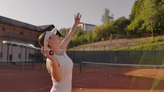 年轻漂亮的女孩打网球。一个穿着白色运动服的女人专业训练网球。年轻漂亮的女孩打网球。网球供应