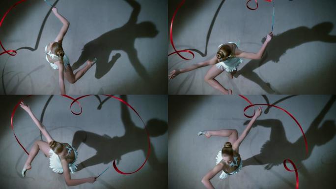 SLO MO LD艺术体操运动员一边优雅地旋转着她的红丝带