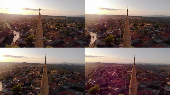 日出时带有尖塔的小镇的鸟瞰图
