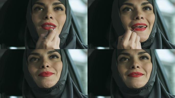 穆斯林妇女使用红色唇膏，明亮的化妆挑战