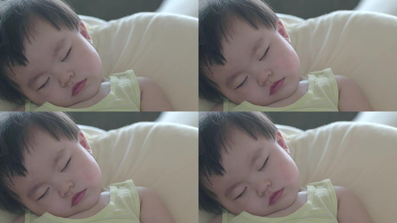 日本婴儿一边喝牛奶一边睡觉。从视图。