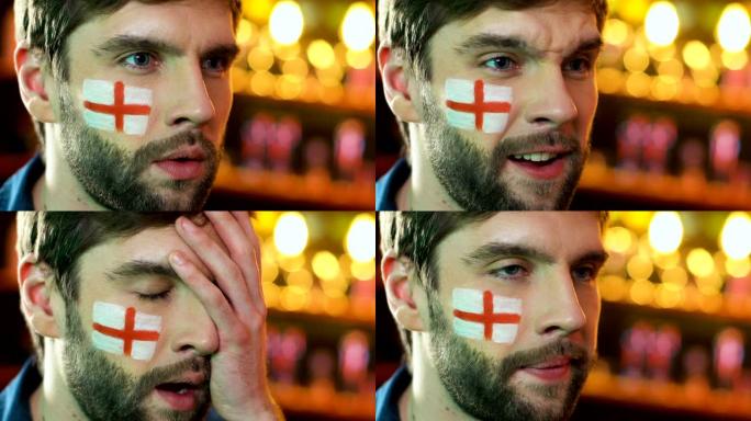 男足球迷带着英国国旗对最喜欢的球队失利感到不安