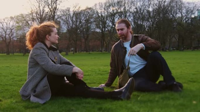 在爱丁堡公园聊天的红发男人和女人的手持镜头