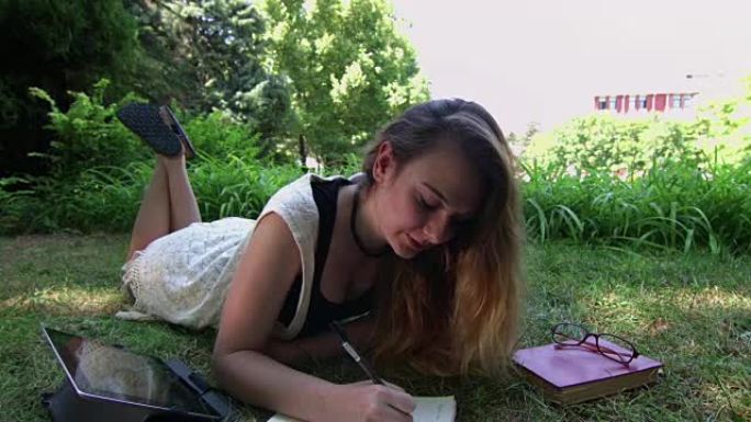 在校学习的女学生在校学习的女学生写字草地