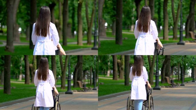 护士在轮椅上通过公园运送养老院的残疾患者