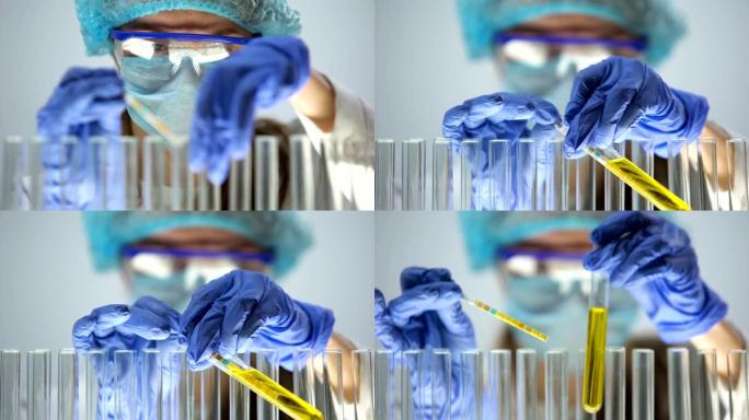 实验室工作人员用石蕊试纸测量黄色液体中的ph值，尿液测试