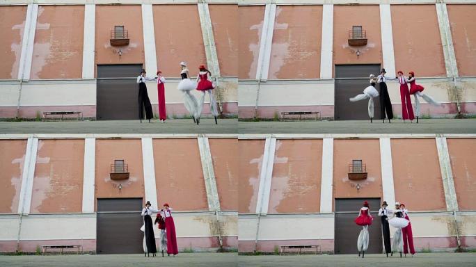 两对高跷的漫画夫妇在建筑物附近跳舞