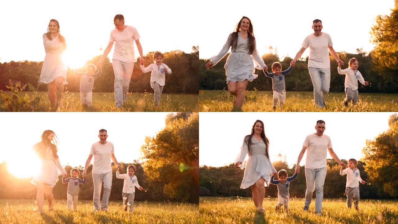 幸福的家庭他们的男人带着两个孩子在夕阳下在田野上散步夏天在温暖的天气里