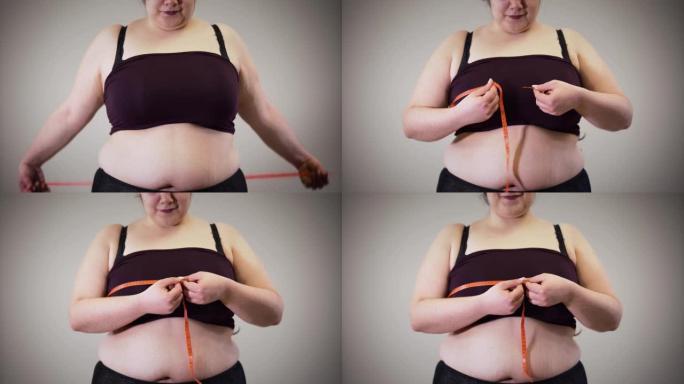 开朗的胖高加索女孩用卷尺测量胸部。穿着内衣的肥胖女性有超重问题。不健康的生活方式，肥胖。