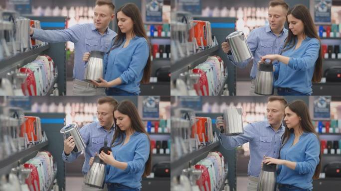 家电商店的年轻夫妇男女选择柜台上的电水壶