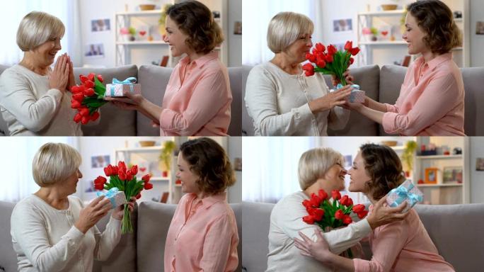 3月8日，有爱心的女儿向母亲送花和礼品盒，家庭之爱