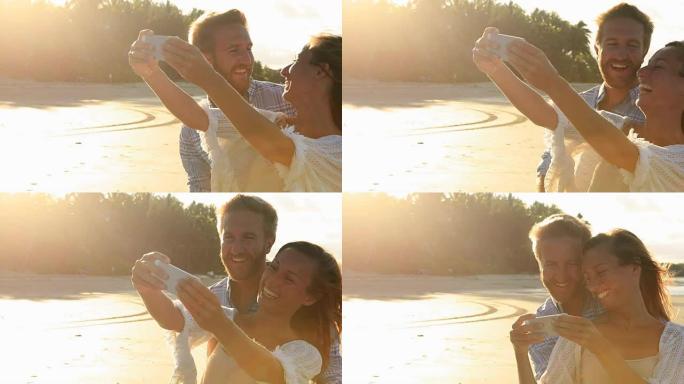 年轻夫妇用自拍海滩捕捉浪漫的假期