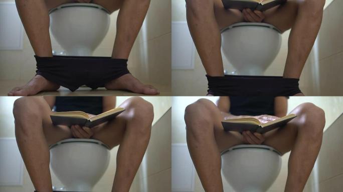 男人坐在浴室的马桶上看书，便秘，无聊