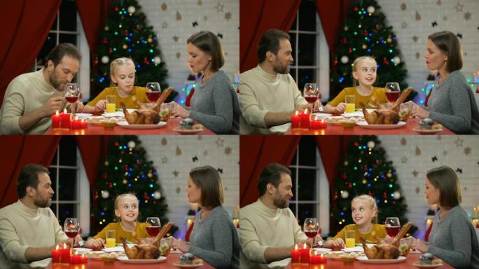 欢快的父母和女儿在圣诞节前夕一起吃新鲜沙拉，一起度假