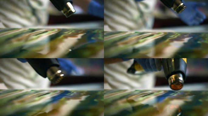 树脂在抽象画中使用热风枪在画布周围移动着色的环氧树脂/树脂